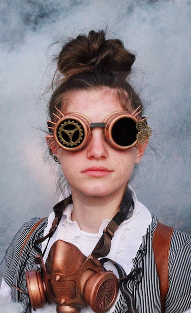 portrait of teenager girl wearing sunglasses with gas mask
