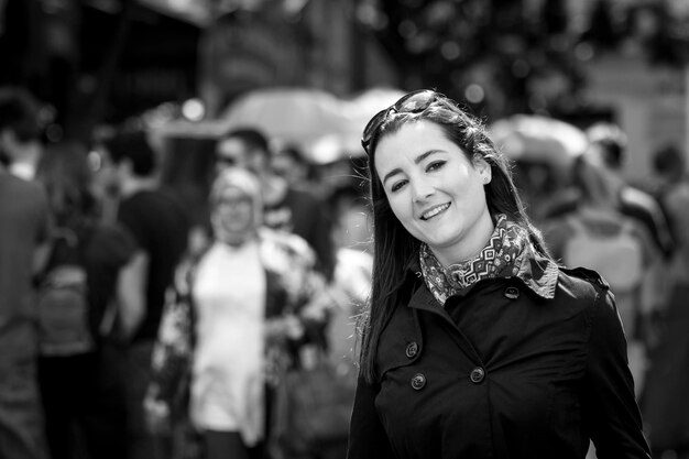 portrait of woman smiling while walking in city