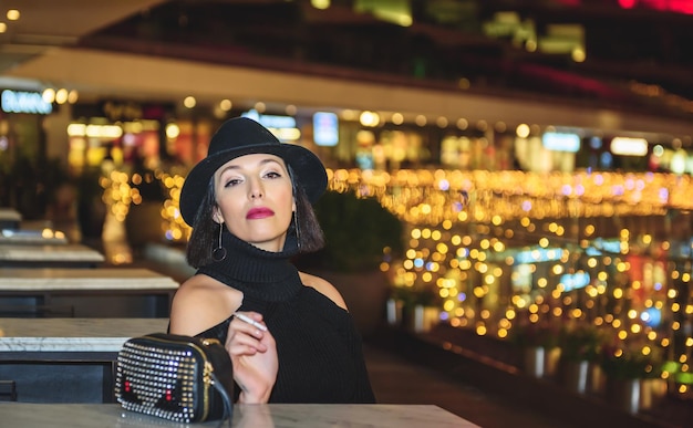 portrait of woman smoking cigarette at night