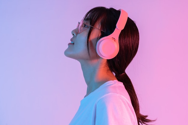 Portrait of young asian girl wearing headphones