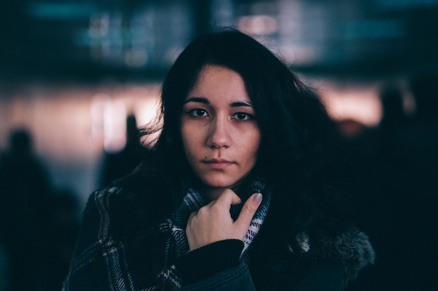 Portrait of young woman wearing jacket and scarf during winter