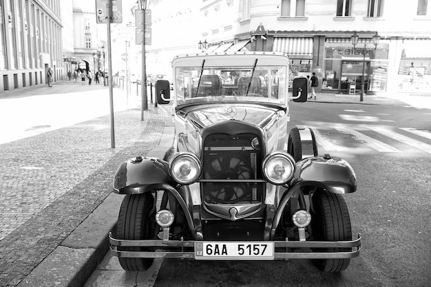 Prague Czech Republic June 03 2017 classic car parked along street side Vintage sightseeing vehicle City tour Transport and transportation Travelling and wanderlust