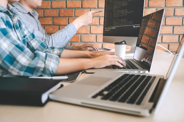 professional developer programmer cooperation meeting and brainstorming and programming in website working a software outsourcing and coding technology, writing codes and database.