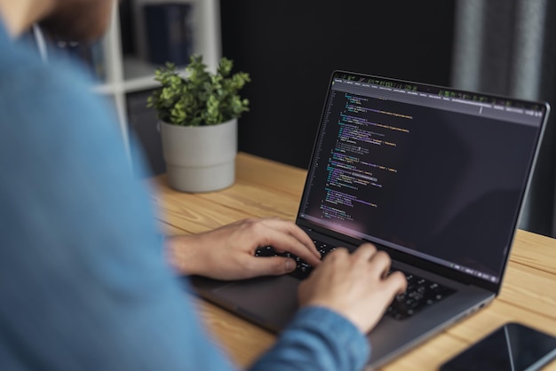 programmer man coding on laptop it