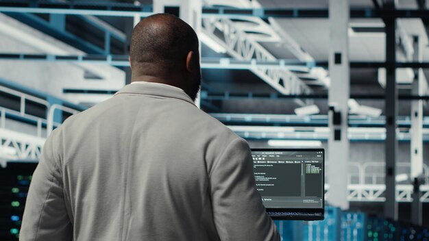 Programmers walking in data center coding doing optimizations using tablet