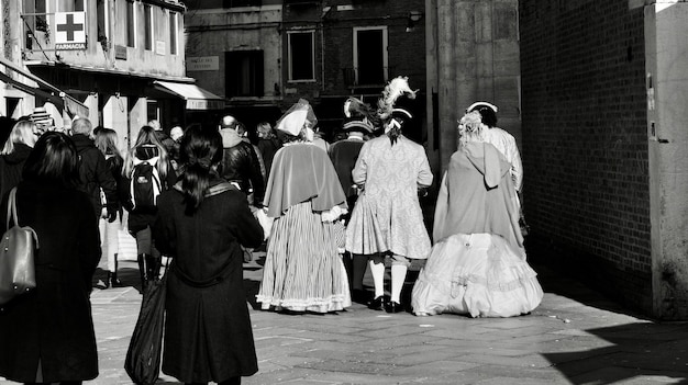 rear view of people standing on street in city