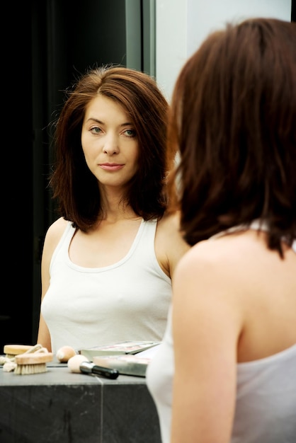 Reflection of woman on mirror at home