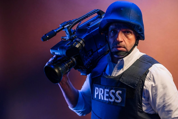 Reporter in bulletproof vest holding a video camera