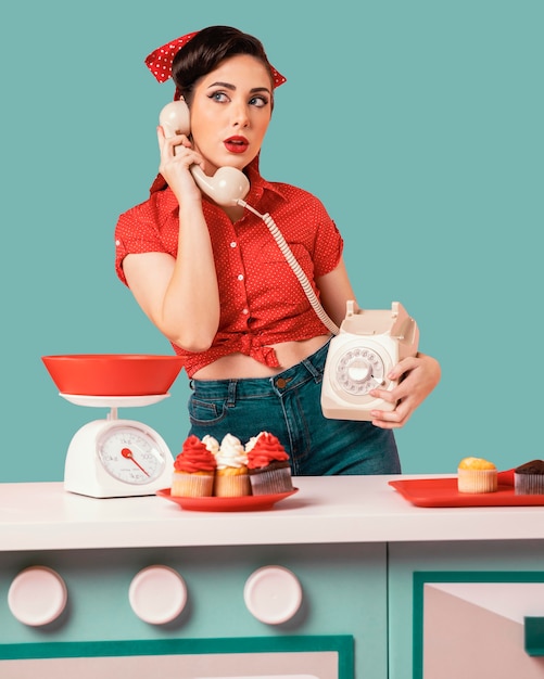 Retro pinup girl posing in a kitchen