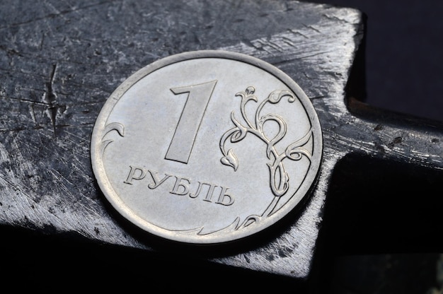russian coin denominated 1 ruble shines on a scratched metal surface closeup translation of the text on the coin quot1 rublequot