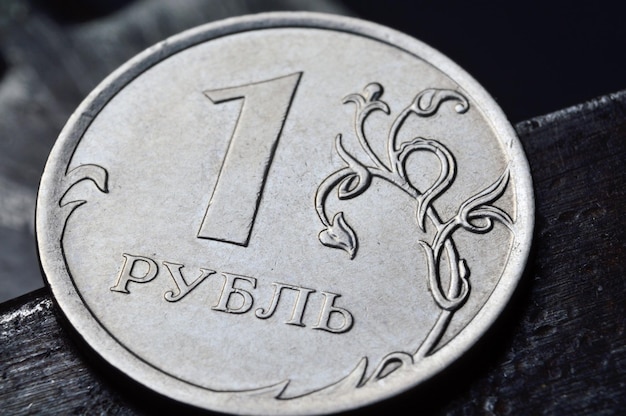 russian coin denominated 1 ruble shines on a scratched metal surface closeup translation of the text on the coin quot1 rublequot