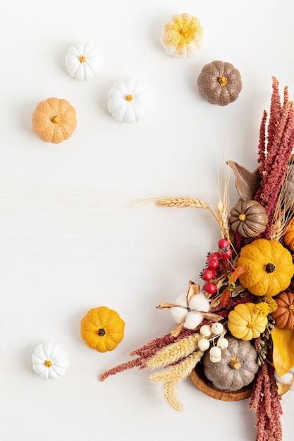 Rustic mockup with autumn table decoration. Floral interior decor for fall holidays with handmade pumpkins. Holiday greeting card. Flatlay, top view