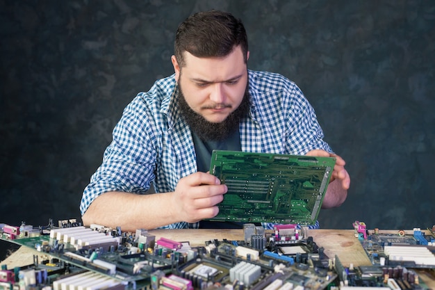 Service engineer work with broken pc hardware. Computer electronic components repairing technology
