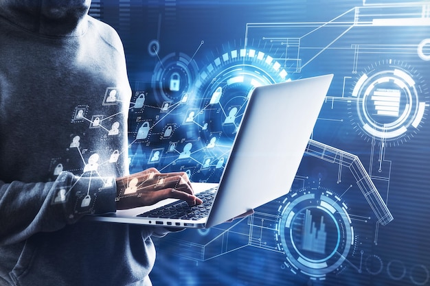 Side view of hacker using laptop with glowing business interface on blurry background Computing theft and criminal concept Double exposure