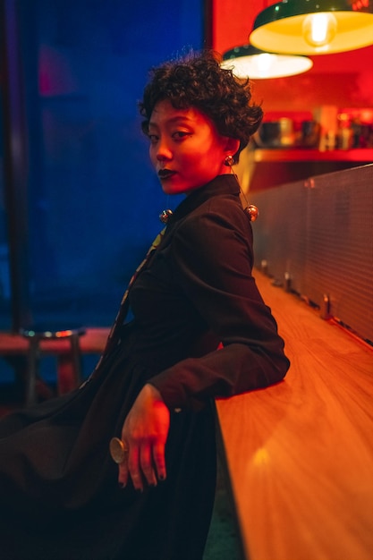 side view of woman looking away at bar table