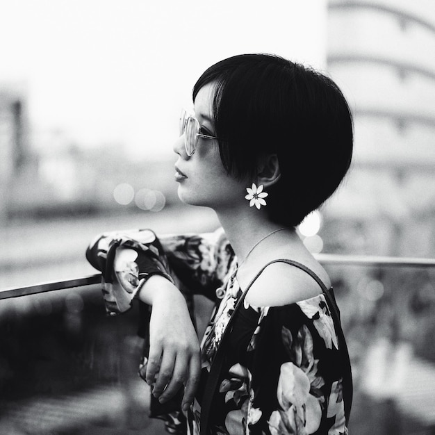 side view of young woman standing in city