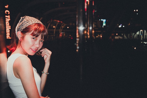 side view portrait of young woman standing at night