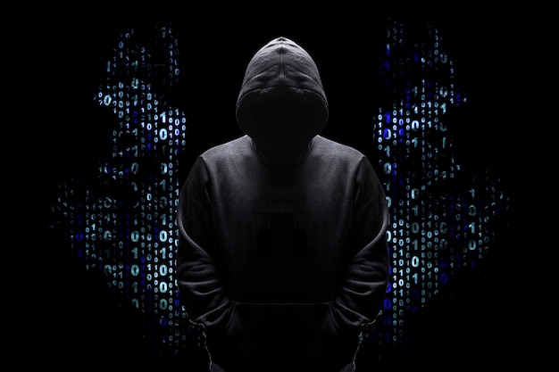 Silhouette of a man in a hood with wings from a binary code, concept angelic good hacker