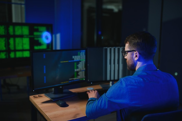 smart male it programer working on desktop