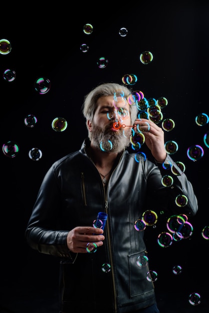 Soap bubbles bearded man blowing bubbles play with bubbles bearded man blowing soap bubbles