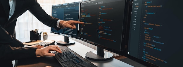 Software development team working together in office coding script display on computer monitor Programmer and software engineer working in tech developer company Trailblazing