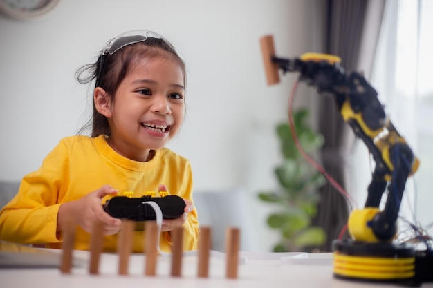 stem education concept asian students learn at home by coding robot arms in stem mathematics engineering science technology computer code in robotics for kids concepts