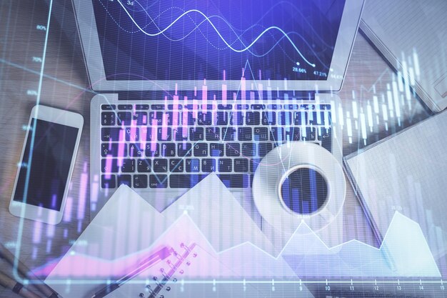 Stock market chart and top view computer on the table background Double exposure Concept of financial analysis