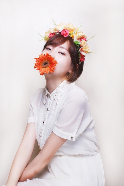 Studio shot portrait of young woman over white background