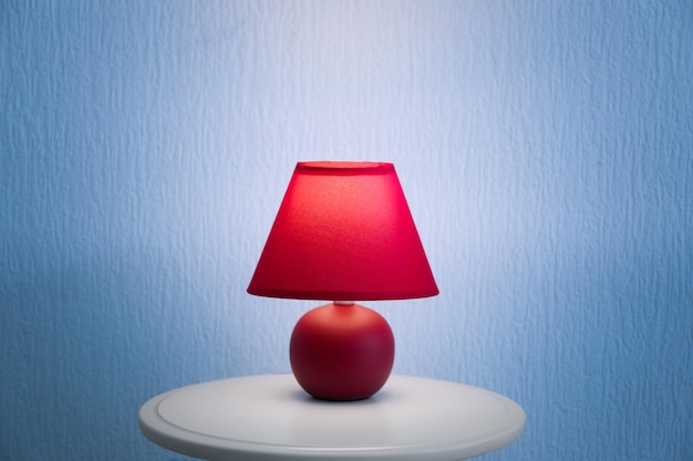 stylish table lamp near color wall