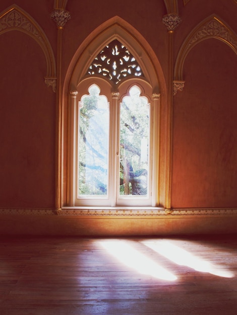 Sunlight falling through arch window of historic building
