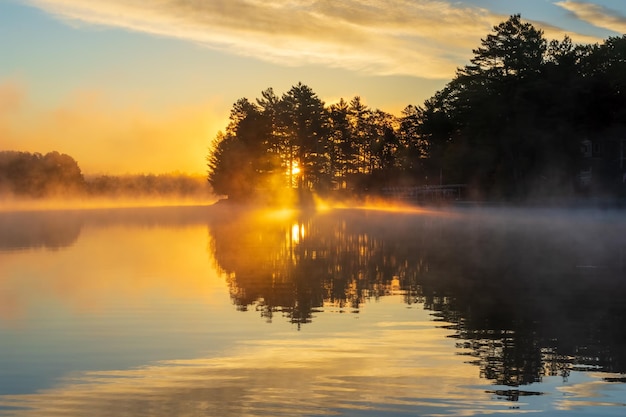 Sunrise over a foggy lake
