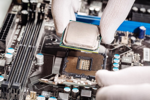 Technicial install cpu chip to mainboard computer