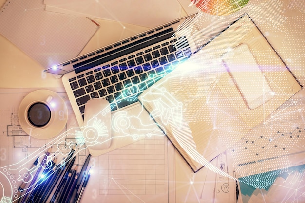 Technology hologram drawing over computer on the desktop background Top view Double exposure Tech concept