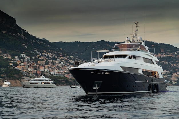 the huge yacht in sea at sunset glossy dark board of the motor boat the chrome plated handrail moore...