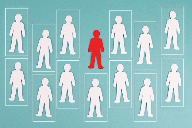 Think outside the box concept, standing out from the crowd, group of people in boxes, one red man