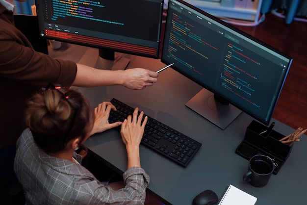 Top view IT developers discussing with point website coding system Infobahn