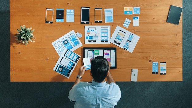 Top view of skilled developer walking and placing ux ui software convocation