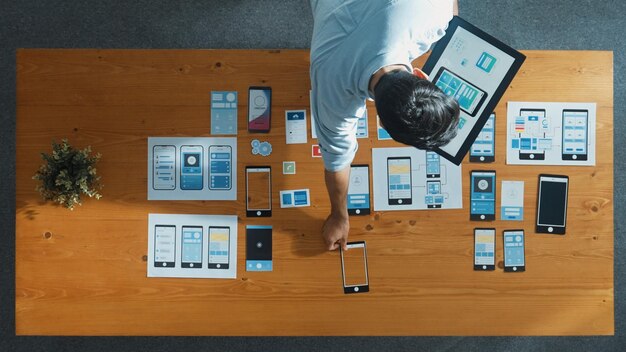 Top view of software developer holding tablet while choosing icon Convocation