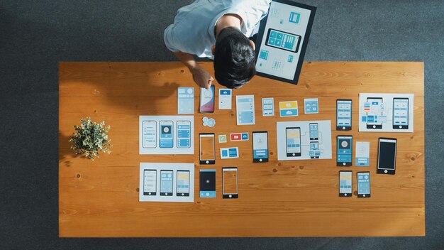 Top view of software developer holding tablet while choosing icon Convocation
