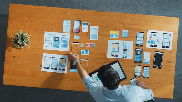 Top view of software developer holding tablet while choosing icon Convocation