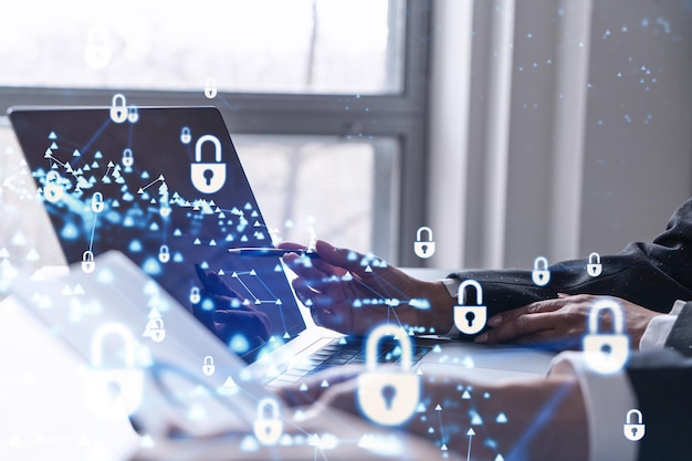 two business people working on the project to protect cyber security of international company using laptop padlock hologram icons teamwork concept