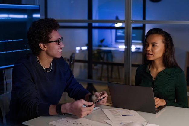 two it specialists at work in evening