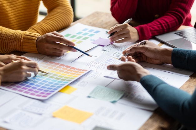 ux ui designers collaborate to design user interfaces for smartphone apps based on user experience colleagues meeting program designers brainstorm to discuss designing mobile applications