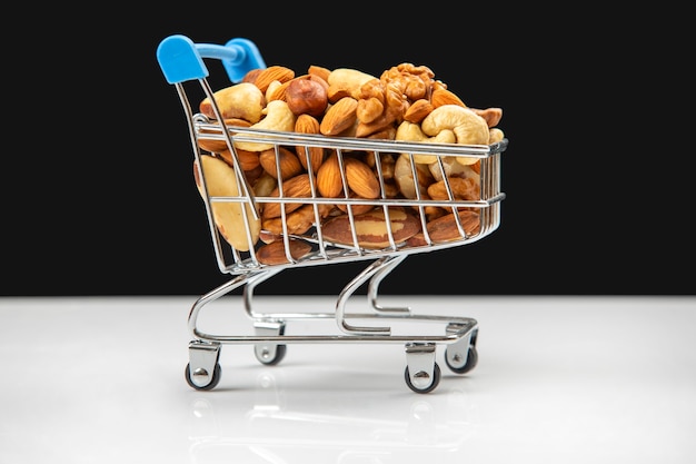 Various types of nuts in the grocery cart. Marketing sale of food products. Vitamin organic protein food