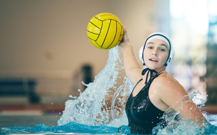 Foto water polo cardio and portrait of a woman with a ball for a competition game and training fitness strong and athlete girl throwing with power action and playing during a professional match