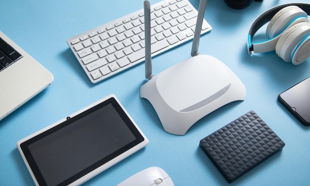 Wi fi router with a tablet phone computer keyboard and other objects