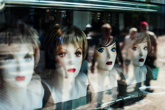 Wigs on mannequins displayed in store