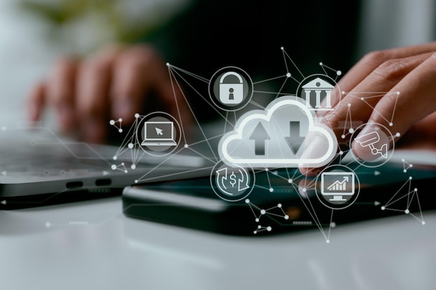 With a cloud computing diagram shown on a laptop a man works on his computer Networking and internet service principles and cloud computing technology