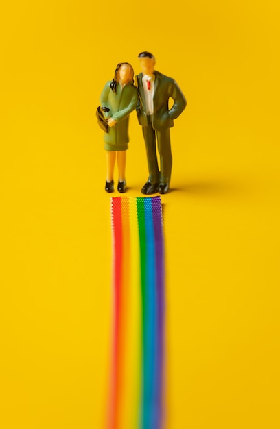Woman and man stands face on rainbow path
