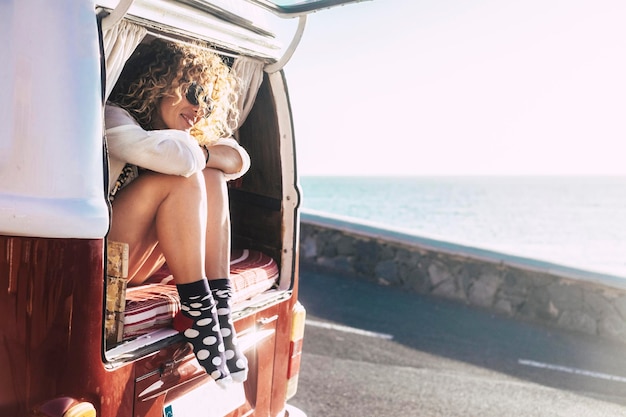 Woman sitting on bed in van